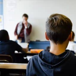 Child listening to a teacher in a class.