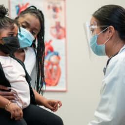 A mother visits the doctor's office with her daughter.