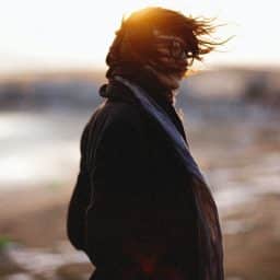 Woman standing outside on a windy day.