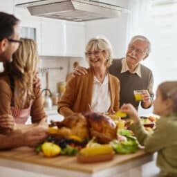 Happy multi-generation family preparing Thanksgiving lunch in the kitchen