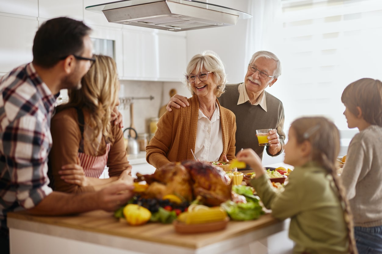 Happy multi-generation family preparing Thanksgiving lunch in the kitchen
